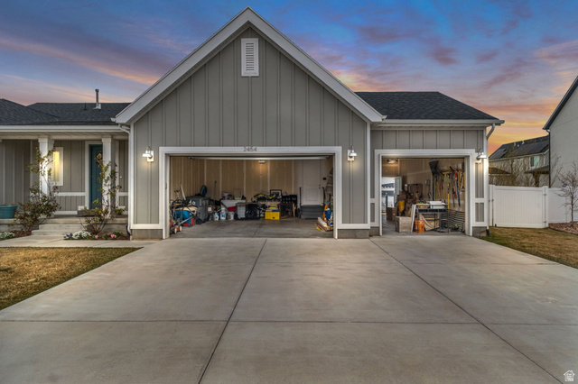 2454 West Jackson Street Mapleton, UT 84664 - Photo 54 of 63 View of front facade with board and batten siding, an attached garage, driveway, and roof with shingles