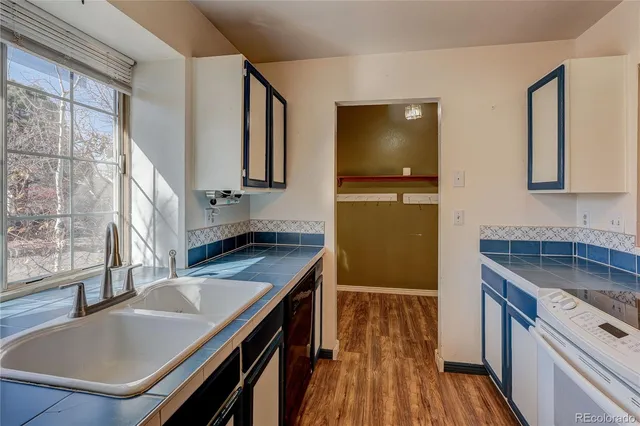 a kitchen with stainless steel appliances granite countertop a sink refrigerator stove and microwave