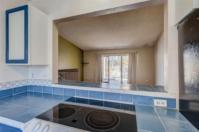 a kitchen with a sink and a stove top oven
