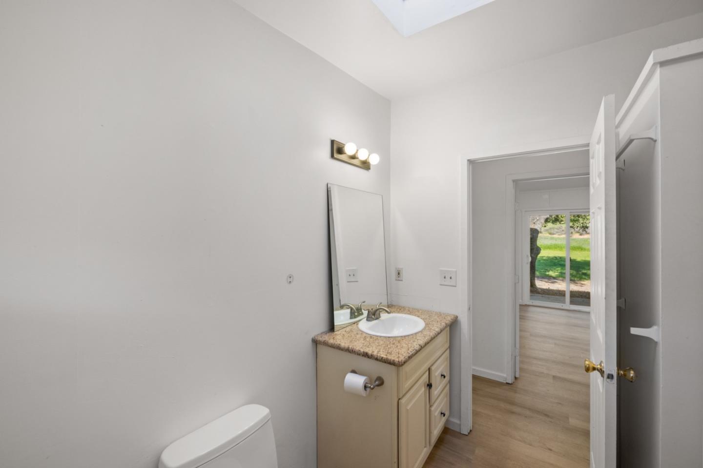 47292 Arroyo Seco Road Greenfield, CA 93927 - Photo 23 of 37 a bathroom with a granite countertop sink and a mirror