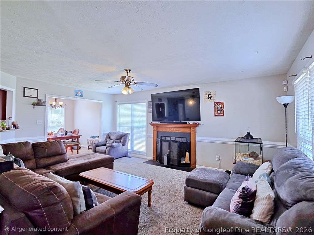 5218 Pringle Way Hope Mills, NC 28348 - Photo 5 of 43 a living room with furniture a fireplace and a flat screen tv