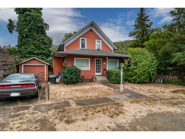 a front view of a house with a garden