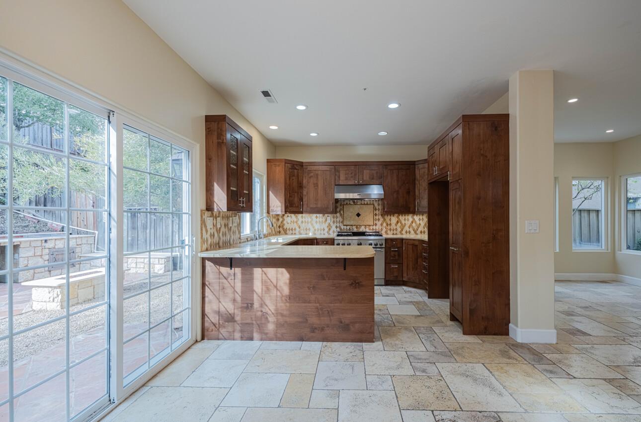 18050 Stonehaven Salinas, CA 93908 - Photo 11 of 32 a kitchen with stainless steel appliances kitchen island granite countertop a refrigerator and a sink