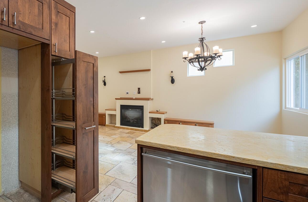 18050 Stonehaven Salinas, CA 93908 - Photo 13 of 32 a kitchen with kitchen island a sink stainless steel appliances and chandelier