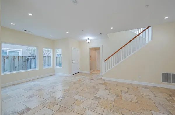 a view of an empty room with windows