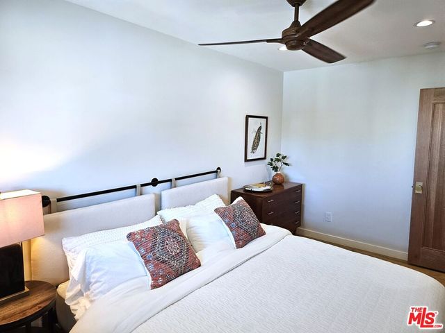 a bedroom with a bed and a night stand