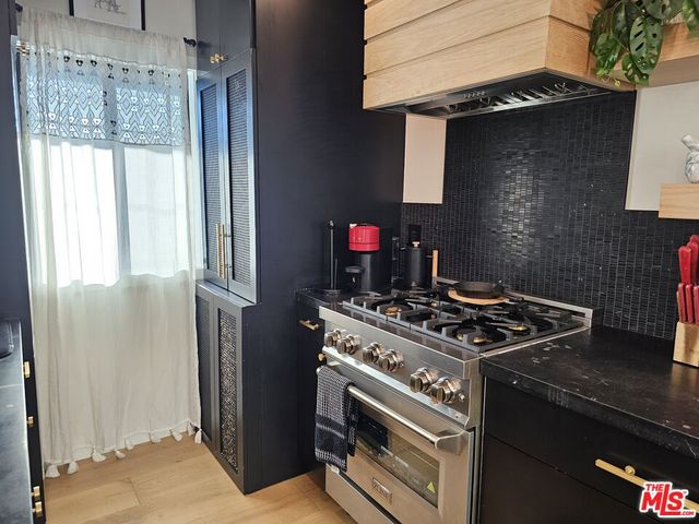 a kitchen with stainless steel appliances granite countertop a stove and a refrigerator
