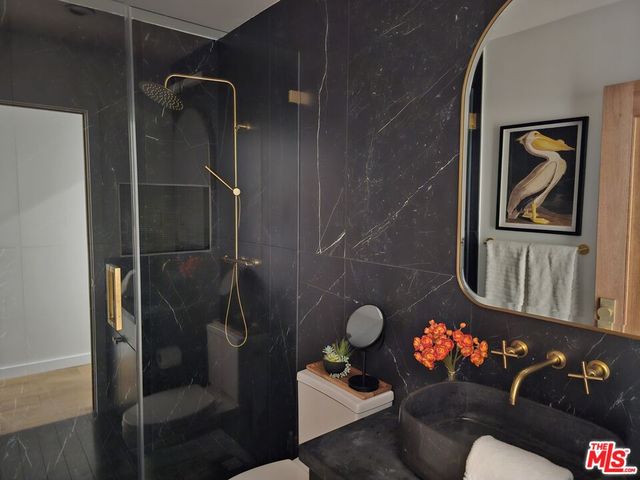 a bathroom with a toilet and a shower