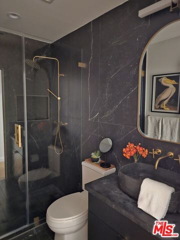 a bathroom with a toilet sink and shower