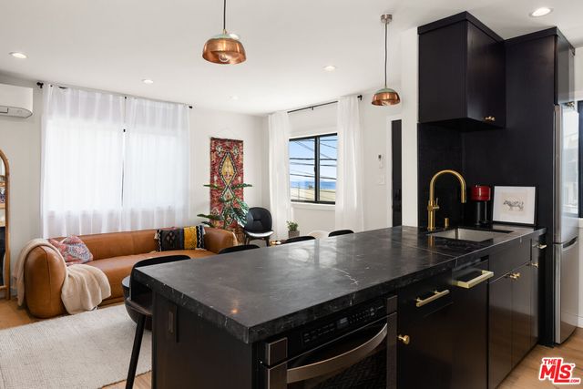 a kitchen with stainless steel appliances a sink a stove and a refrigerator