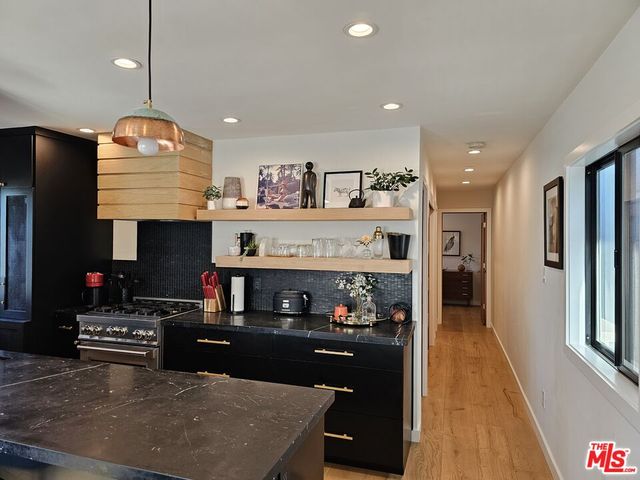 a kitchen with stainless steel appliances granite countertop a stove and a refrigerator