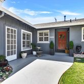 a view of a house with swimming pool and sitting area