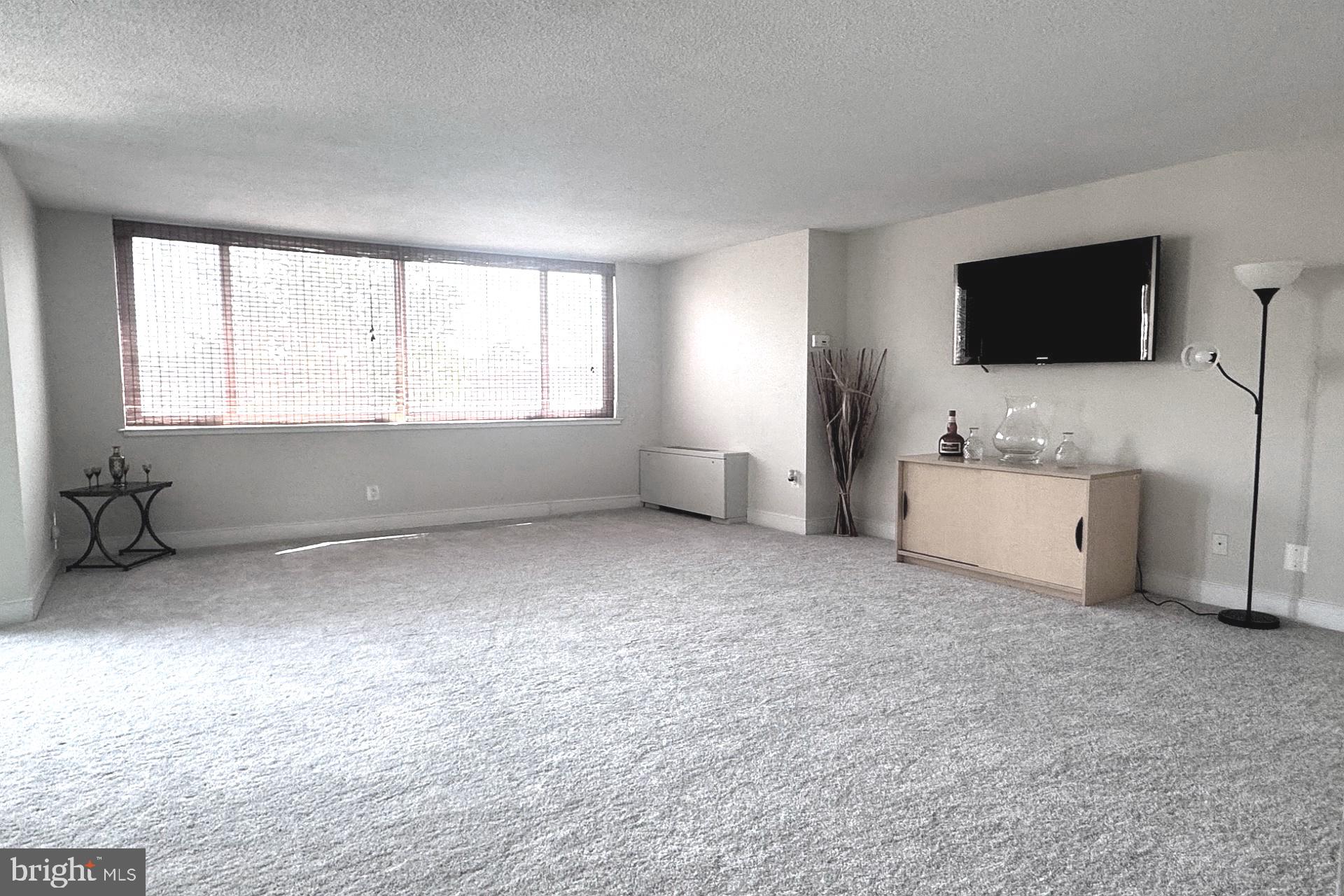 1220 Blair Mill Road, Unit 405 Silver Spring, MD 20910 - Photo 11 of 39 a living room with furniture and a flat screen tv