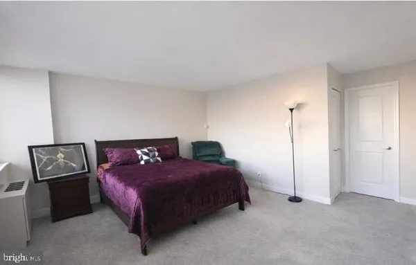 a bedroom with a bed and a night stand