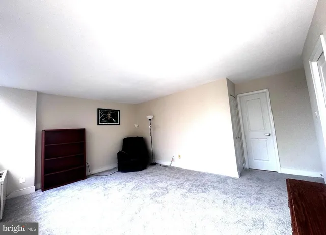 a view of empty room with closet and cabinet