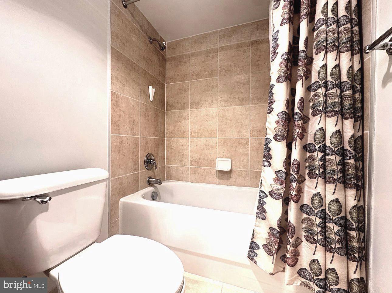 1220 Blair Mill Road, Unit 405 Silver Spring, MD 20910 - Photo 31 of 39 a white toilet sitting next to a bath tub