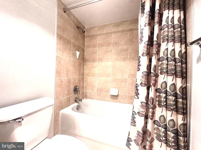 a bathroom with a bathtub and shower