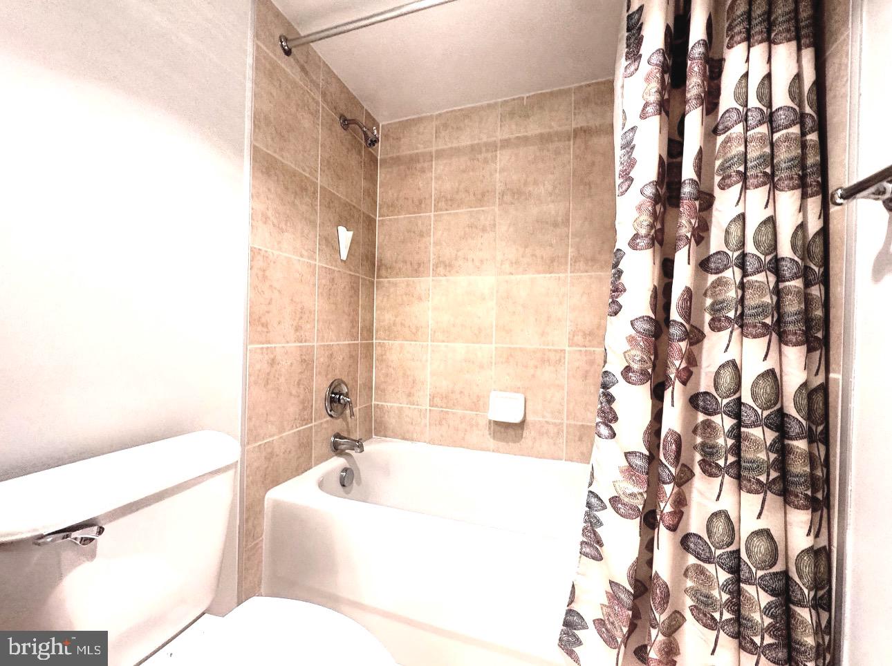 1220 Blair Mill Road, Unit 405 Silver Spring, MD 20910 - Photo 32 of 39 a bathroom with a bathtub and shower