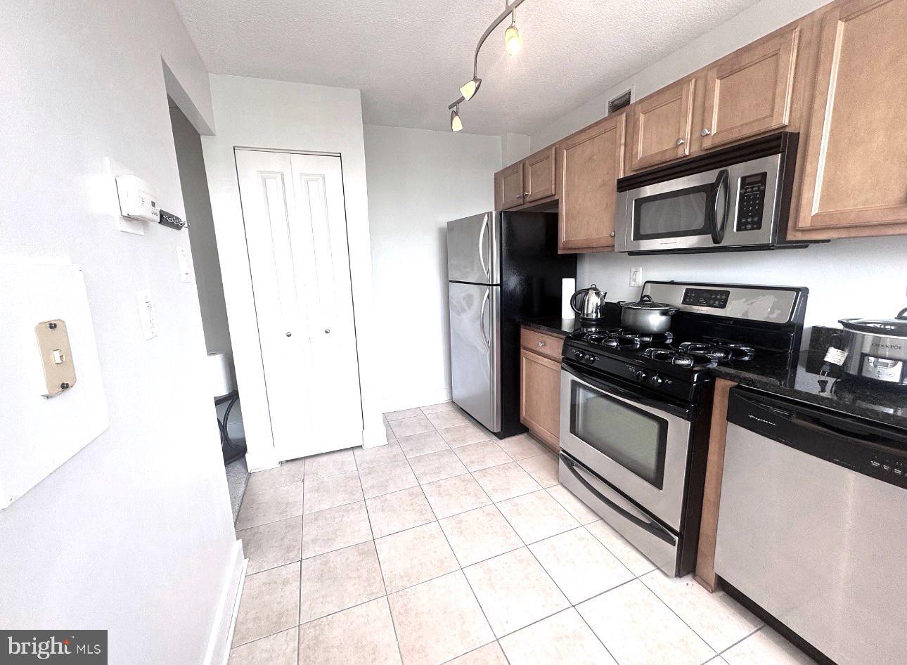 1220 Blair Mill Road, Unit 405 Silver Spring, MD 20910 - Photo 5 of 39 a kitchen with stainless steel appliances granite countertop a refrigerator and a stove top oven