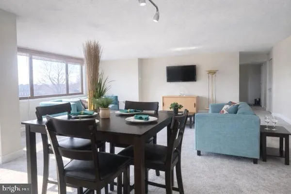 a view of a dining room with furniture and window