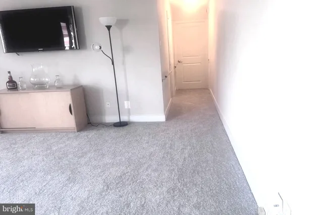 a view of a kitchen from the hallway