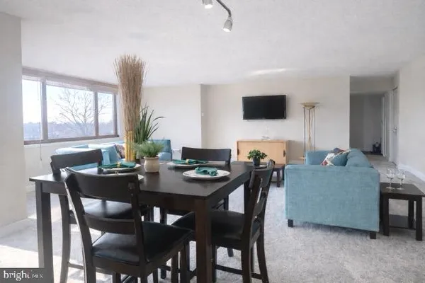 a view of a dining room with furniture and window