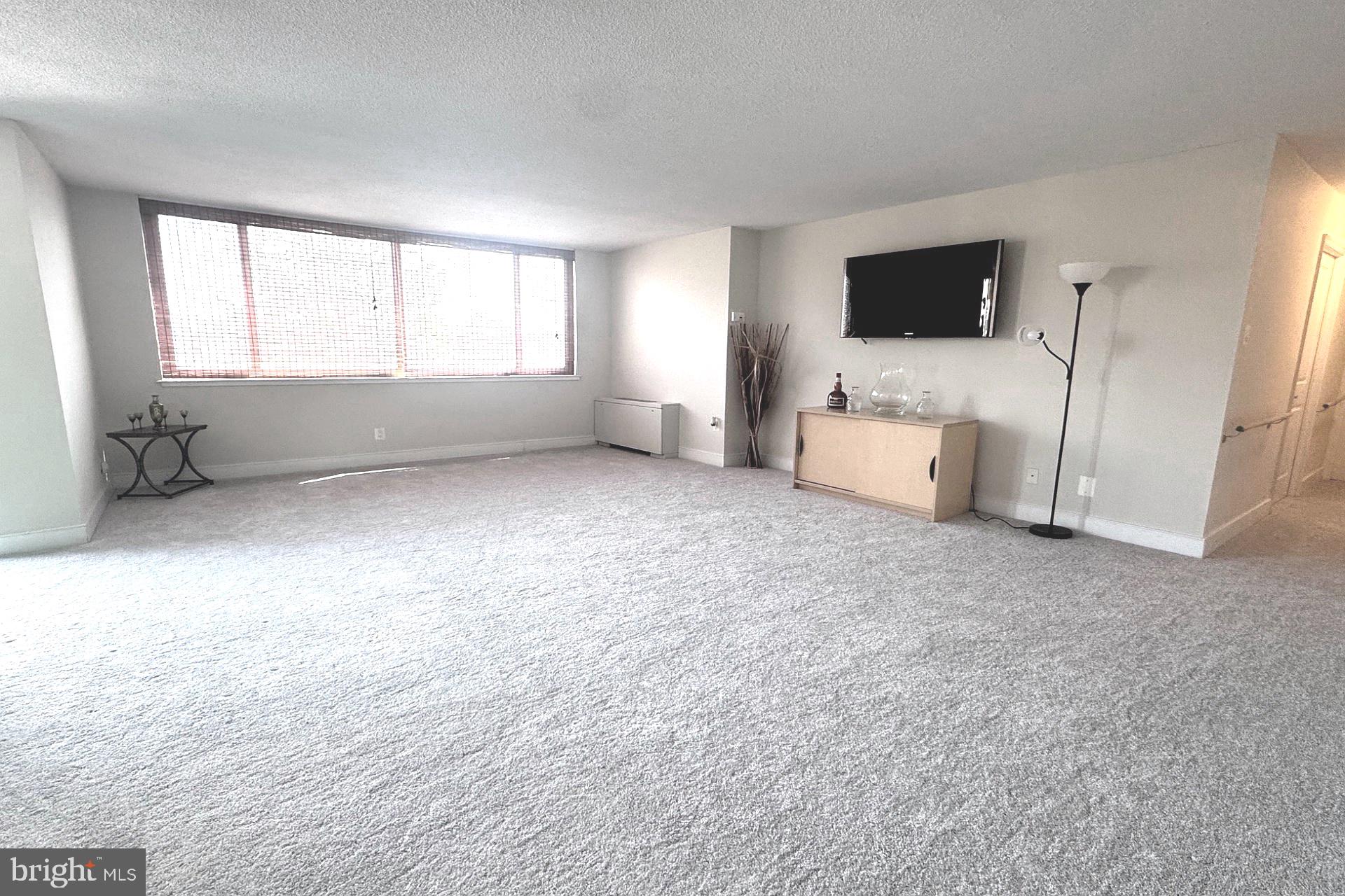 1220 Blair Mill Road, Unit 405 Silver Spring, MD 20910 - Photo 9 of 39 a room with a bed and a flat screen tv