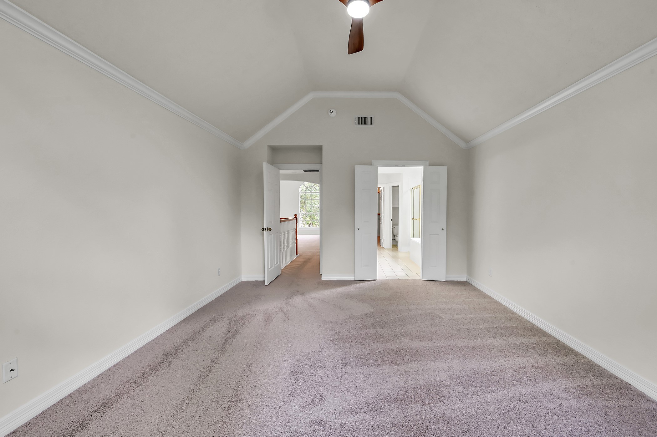 18310 Rittenhouse Park Court Spring, TX 77379 - Photo 17 of 35 This huge primary suite features new paint, brand new carpet, new ceiling fan, high vaulted ceilings and crown molding.