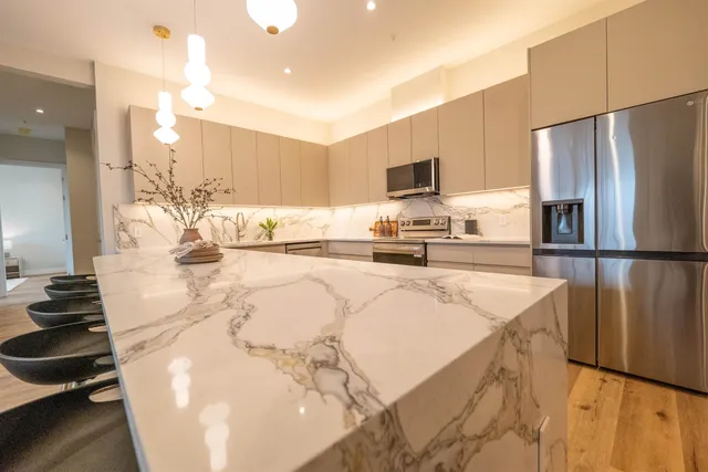 a kitchen with stainless steel appliances a refrigerator sink and stove