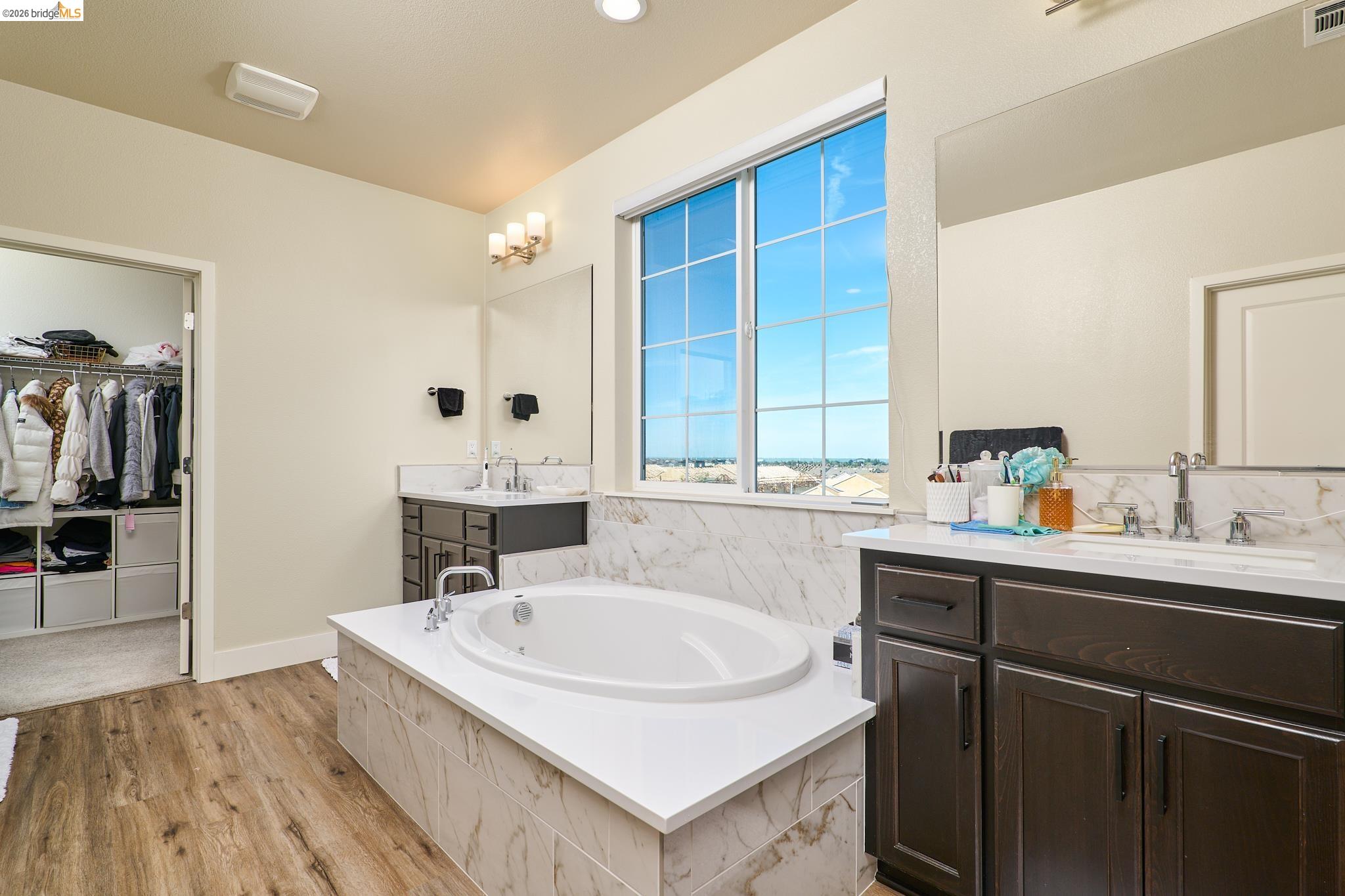 5532 Promontory Way Antioch, CA 94531 - Photo 24 of 45 Full bath with a garden tub, a walk in closet, two vanities, and light wood-style floors