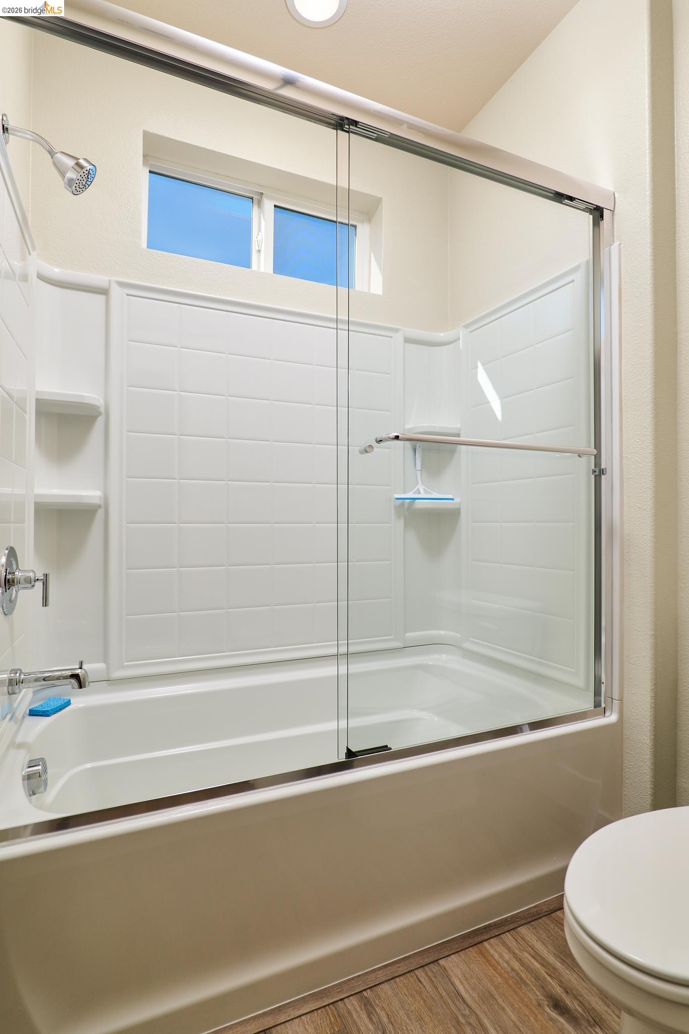 5532 Promontory Way Antioch, CA 94531 - Photo 26 of 45 Bathroom featuring bath / shower combo with glass door and wood finished floors