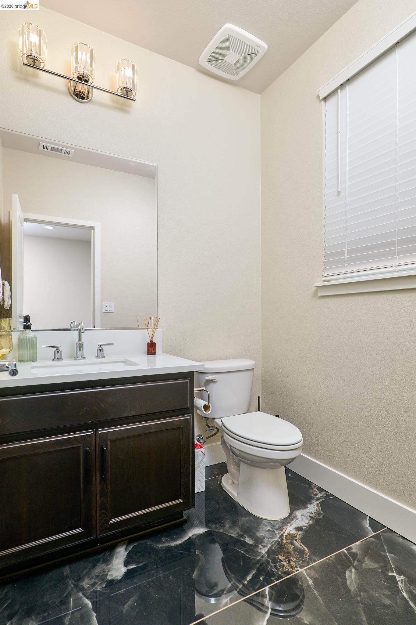 5532 Promontory Way Antioch, CA 94531 - Photo 28 of 45 Half bathroom with vanity and dark marble finish flooring