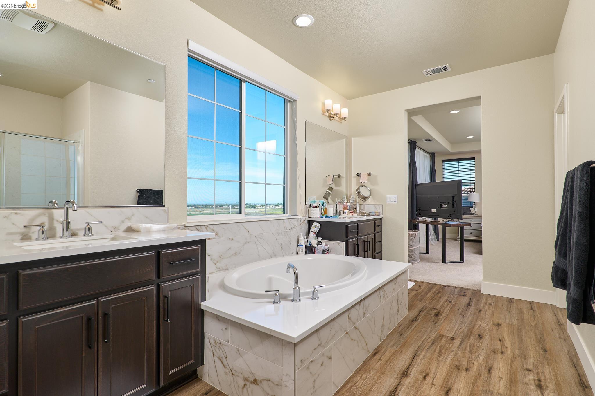 5532 Promontory Way Antioch, CA 94531 - Photo 29 of 45 Bathroom with a bath, light wood finished floors, two vanities, a shower stall, and recessed lighting