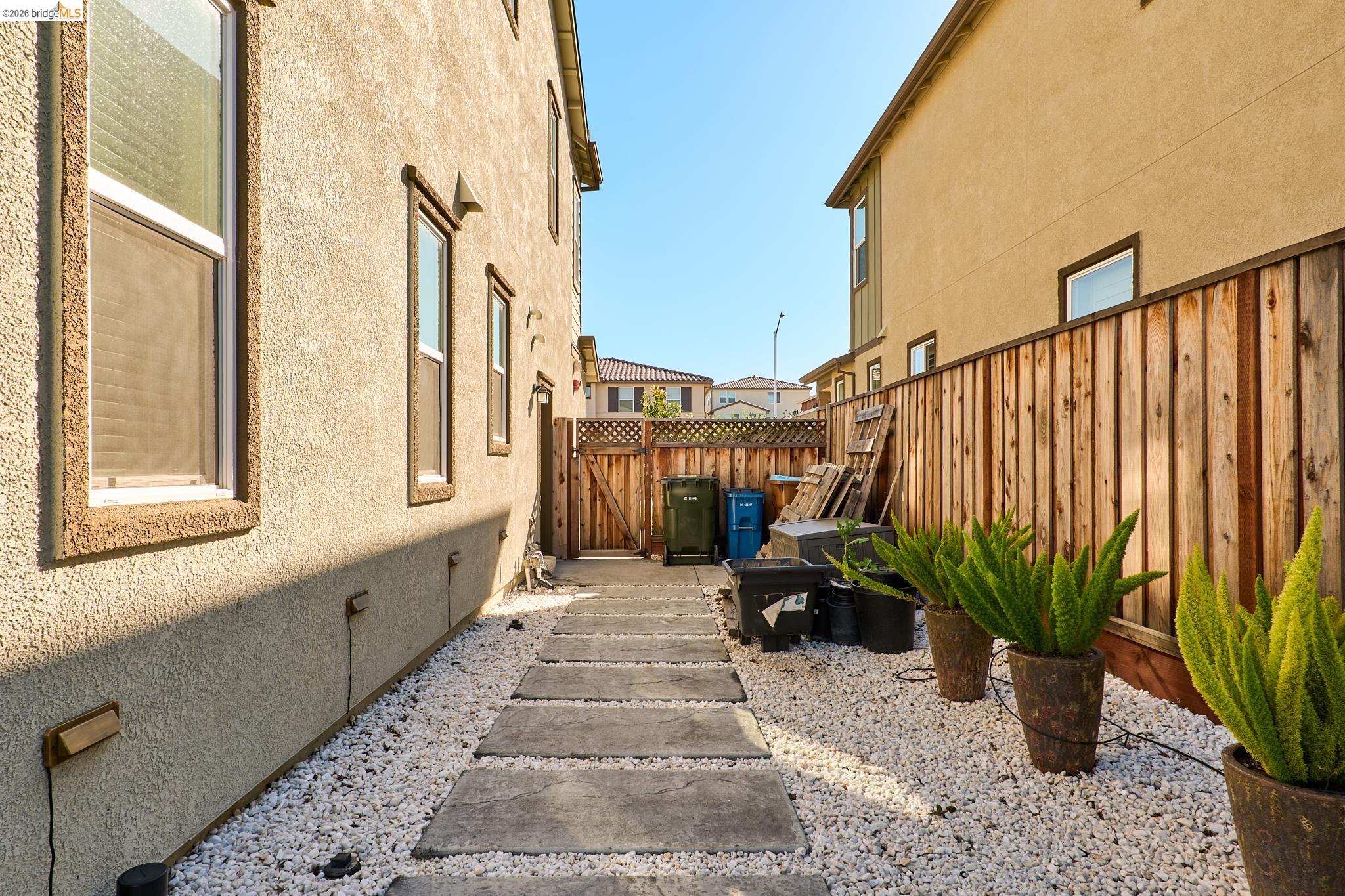 5532 Promontory Way Antioch, CA 94531 - Photo 44 of 45 View of home's exterior featuring a fenced backyard, stucco siding, a gate, and crawl space