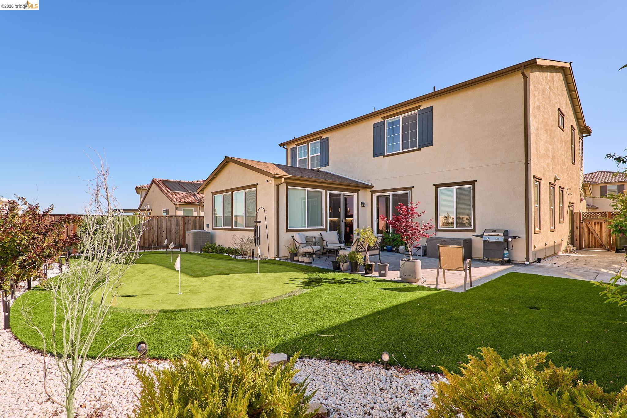 5532 Promontory Way Antioch, CA 94531 - Photo 45 of 45 Back of house with a fenced backyard, a patio area, stucco siding, and a putting area