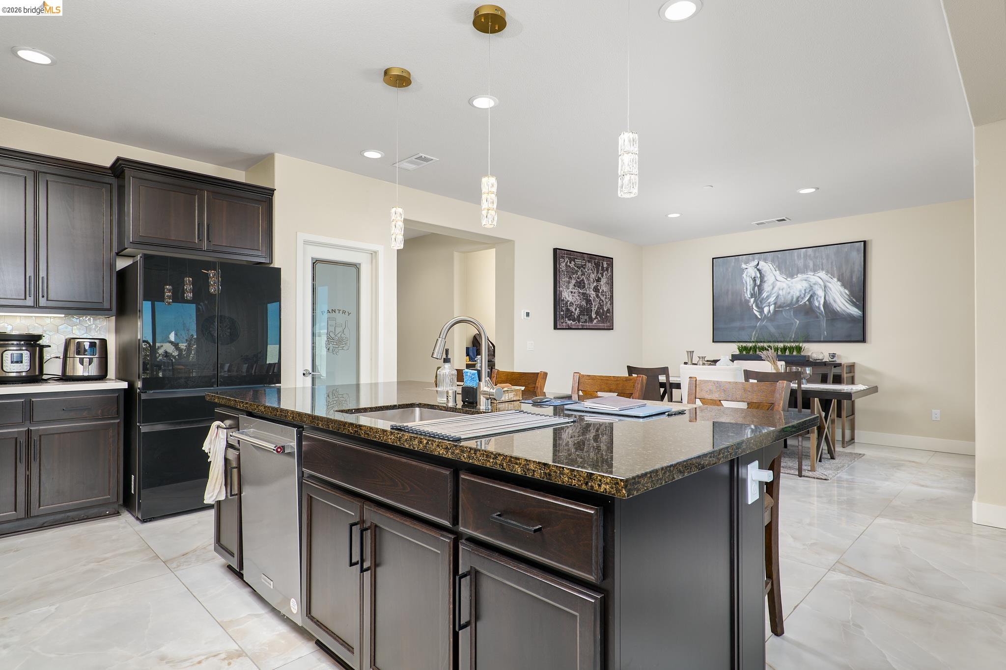 5532 Promontory Way Antioch, CA 94531 - Photo 6 of 45 Kitchen featuring dark wood finish cabinetry, dark stone counters, smart refrigerator, and pendant lighting