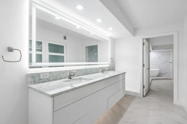 a bathroom with a shower and a glass door