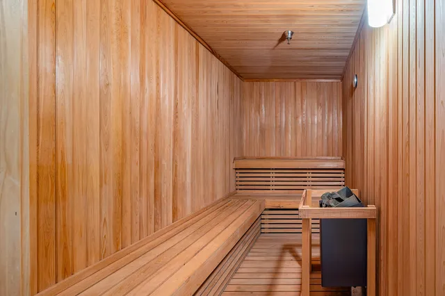 a view of a closet with wooden floor