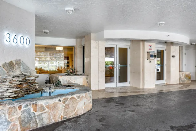 a living room with granite countertop lots of furniture and a window