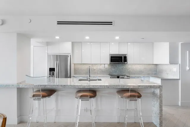 a kitchen with lots of counter top space and stainless steel appliances
