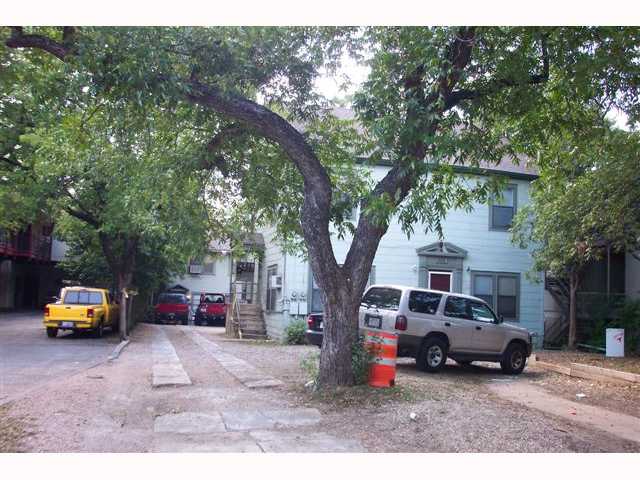 a car parked in front of white house