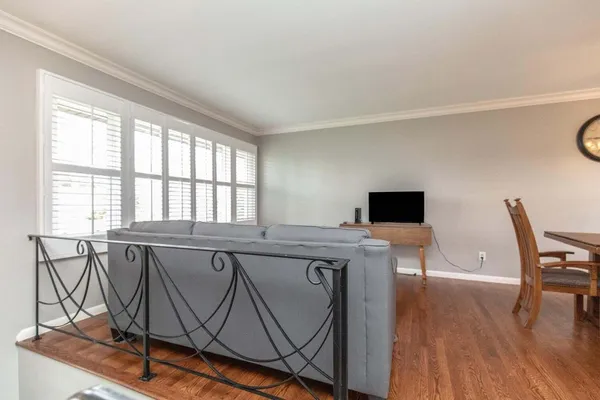 a view of a dining room with furniture and wooden floor