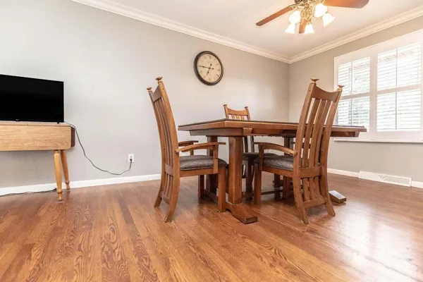 a view of a dining room with furniture and a large window