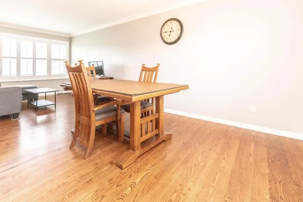 a view of a dining room with furniture and wooden floor