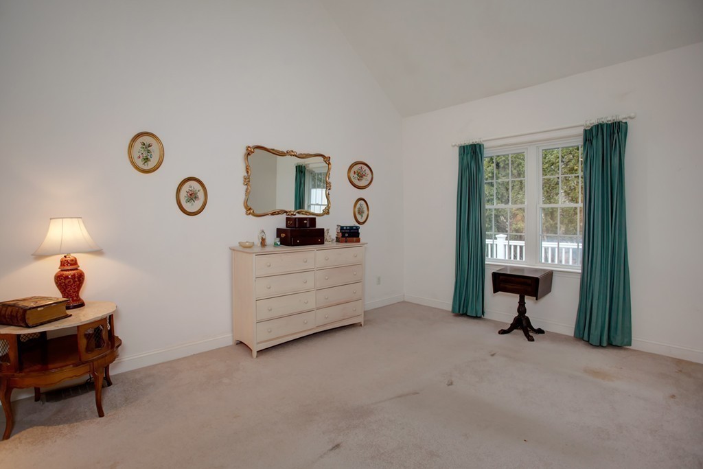 51 Stratford Ridge, Unit 152 Mashpee, MA 02649 - Photo 16 of 28 a bedroom with bed and a lamp next to a window