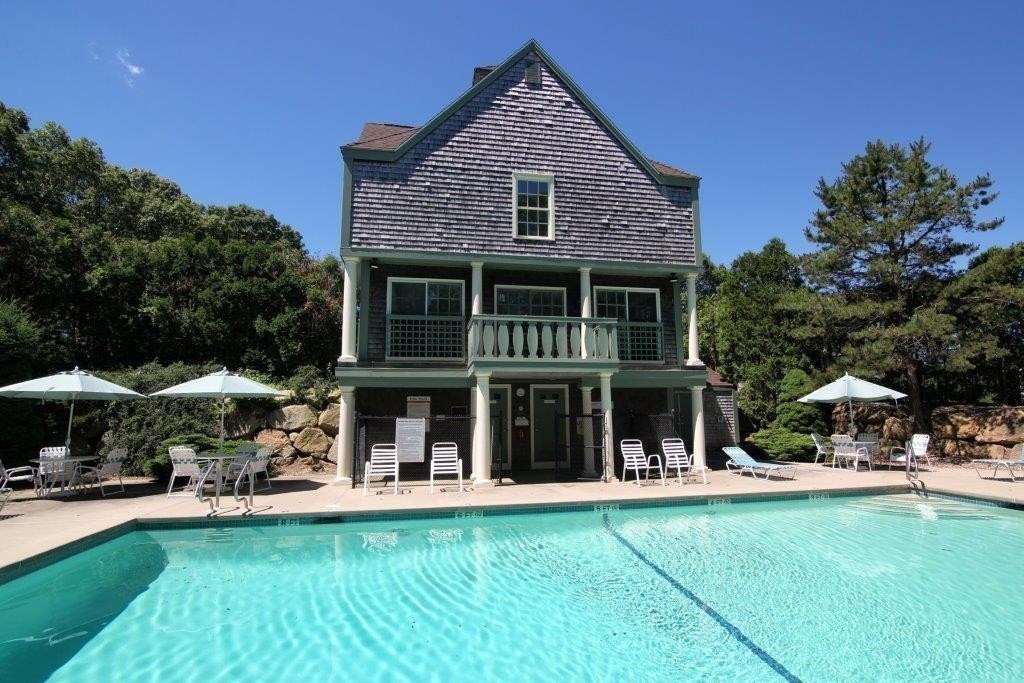 51 Stratford Ridge, Unit 152 Mashpee, MA 02649 - Photo 26 of 28 a view of house with yard outdoor seating and swimming pool
