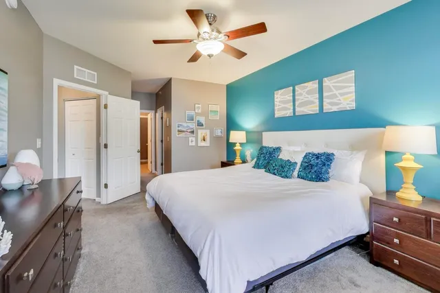 a bedroom with a bed and a chandelier