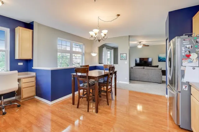a view of a dining room with furniture and chandelier