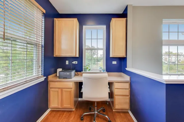 a view of a kitchen with a window a sink and a table in it