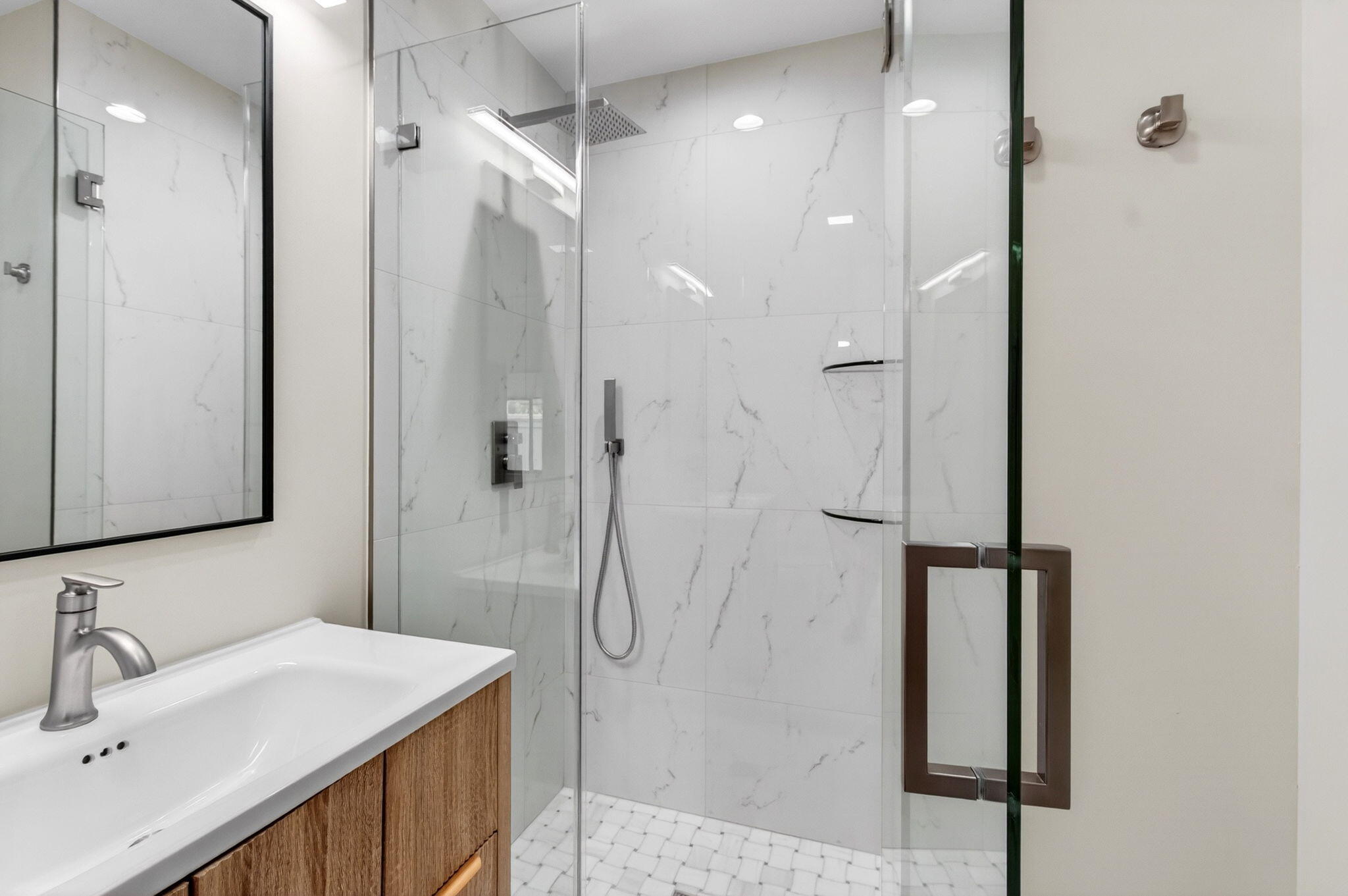 1330 Northwest 13th Street, Unit 12 Boca Raton, FL 33486 - Photo 40 of 52 a bathroom with a shower sink and mirror